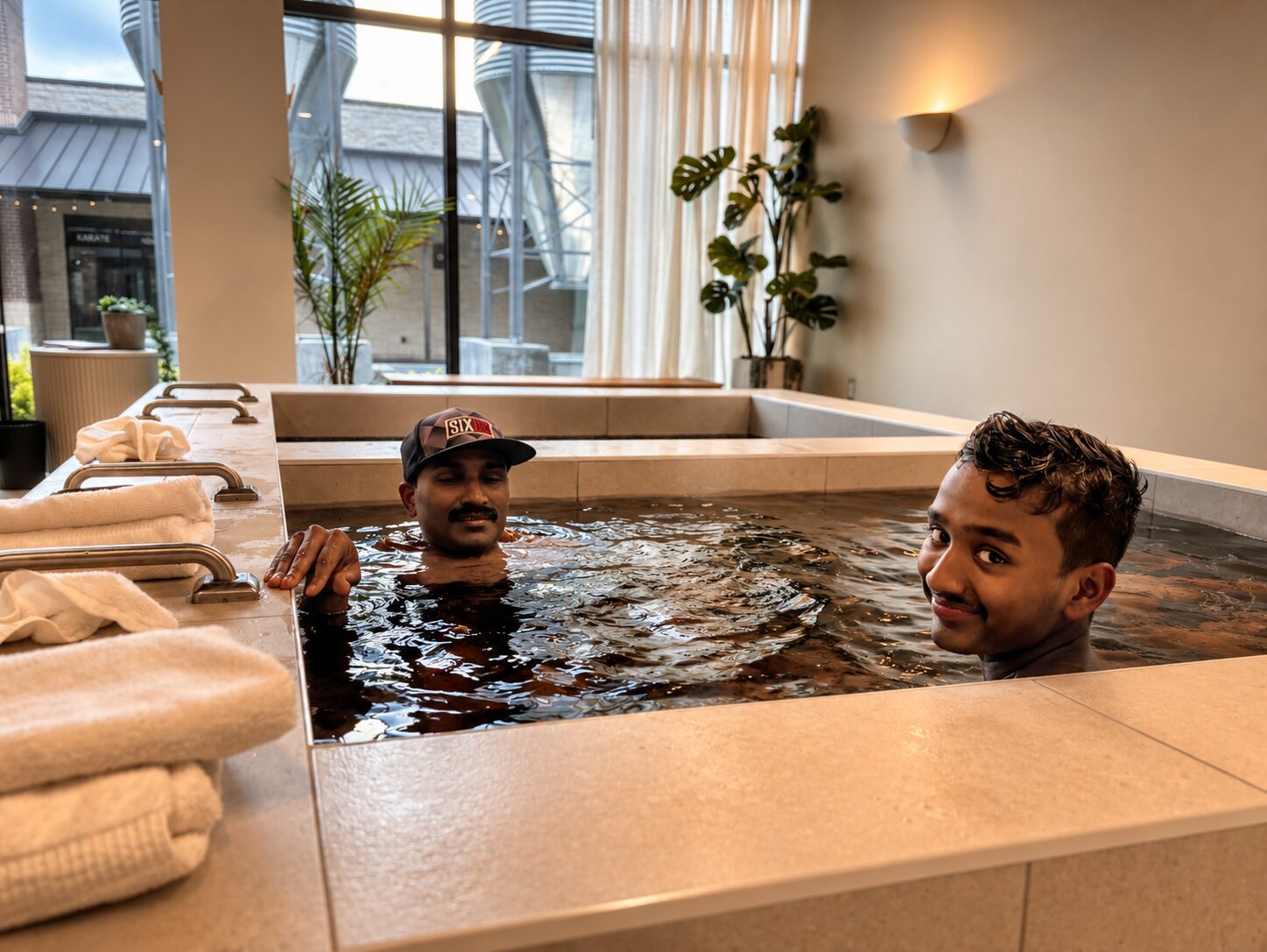 Father and son using a cold plunge at Ash & Sage Sauna Spa in Melissa, TX